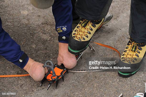 Quinn Simons, who lost all of his fingers and both of his feet to frostbite while climbing in China, gets crampons prepared before heading out for...