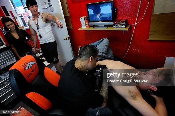 P.m. Ian and Devin watch as BuddhaO gets a tattoo of brass knuckles. Ian gets a matching one. It represents all the trouble we have gotten into...