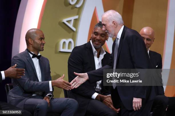 Inductee Gregg Popovich shakes hand with fellow inductee and former player Tony Parker during the 2023 Naismith Basketball Hall of Fame Induction at...