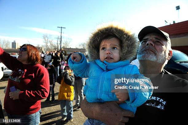 Chester Moyer holds his great granddaughter Elissa Moyer-Cante while watching Santa's helicopter land at Lupita's Restaurant in Aurora, CO, Saturday...