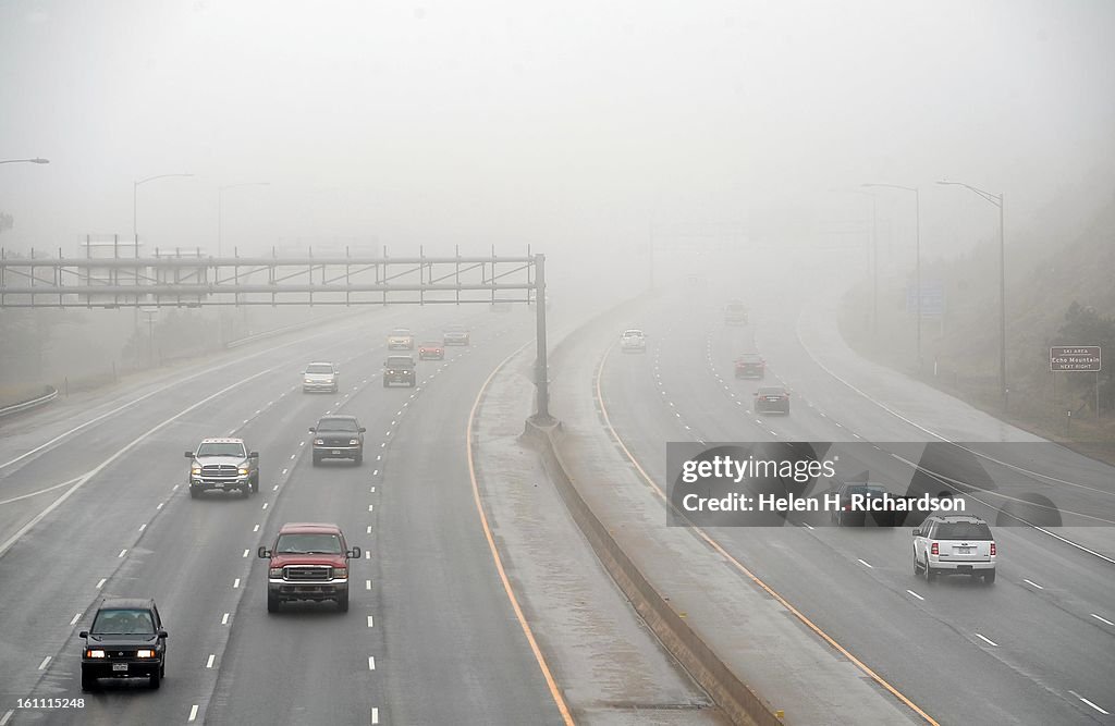 (HR) The foothills near Evergreen Parkway and I-70 have been shrouded in fog most of the day. Snow has begun to blanket trees at higher altitudes above Idaho Springs. A big spring snowstorm is forecast to hit the metro area and foothills after midnight to