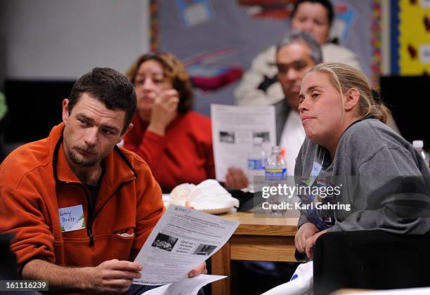 And HEATHER MCLEOD listen to Rose Hill Elementary School principal Samara Williams during a parents meal and meeting at the school Wednesday night....