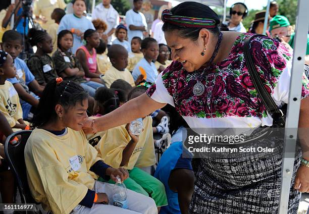 Nobel Peace Laureate Rigoberta Menchu Tum reaches out to say hello to Isela Torres and the other children attending the Holly Day of Action Project....