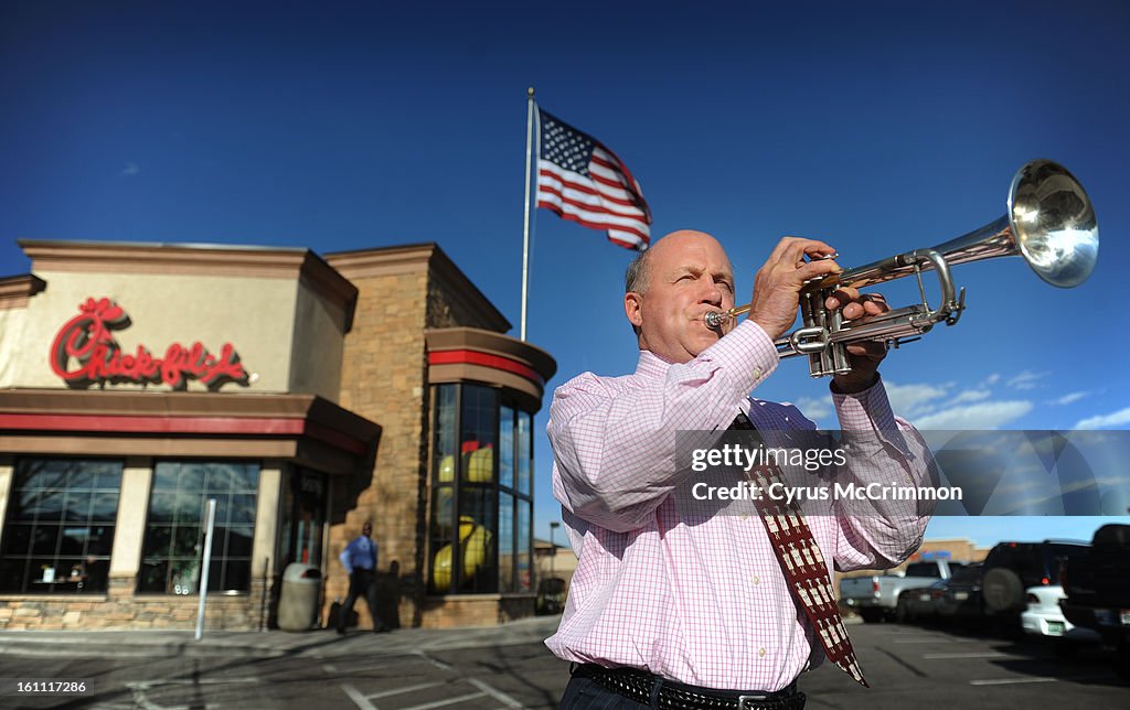 (cm ) BZ22CHICK_CM01 Chick-fil-A Inc. president and COO Dan Cathy, son of the chain's founder Truett Cathy, sounds the trumpet while visiting one of his franchises in Littleton, 9976 W. Remington Place, on Monday, April 20, 2009. Later in the week on Thur