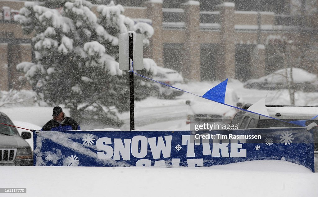 The Firestone store on Bergen Parkway in Evergreen advertises for snow tires as a fall snow storm dumped the foothills west of Denver with at least 12 inches of snow and more continues to accumulate as the snow continues to fall. Wednesday October 28, 200
