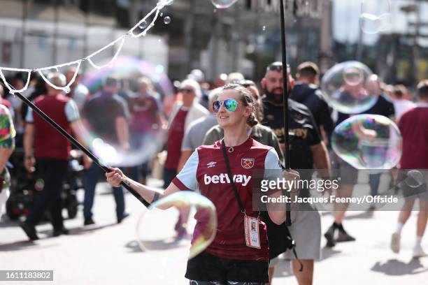 Someone makes bubbles outside the stadium during the Premier League match between West Ham United and Chelsea FC at London Stadium on August 20, 2023...