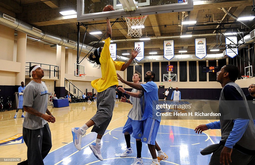 (HR) Denver Nuggets Chris Andersen and NeNe try to stop Renaldo Balkman as he goes up for a lay-up during practice. At left is Kenyon Martin, at right is Carmelo Anthony. The Denver Nuggets practiced today at the Pepsi Center in preparation of their upcom