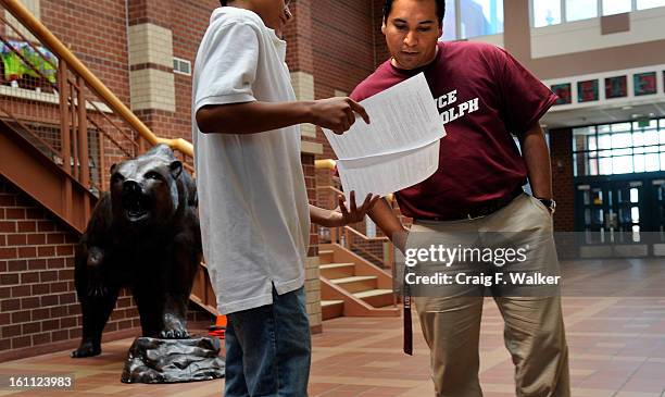 Principal Cesar Cedillo talks with a student in the atrium at Bruce Randolph Middle School, Denver, CO. Bruce Randolph is the only school in Denver...