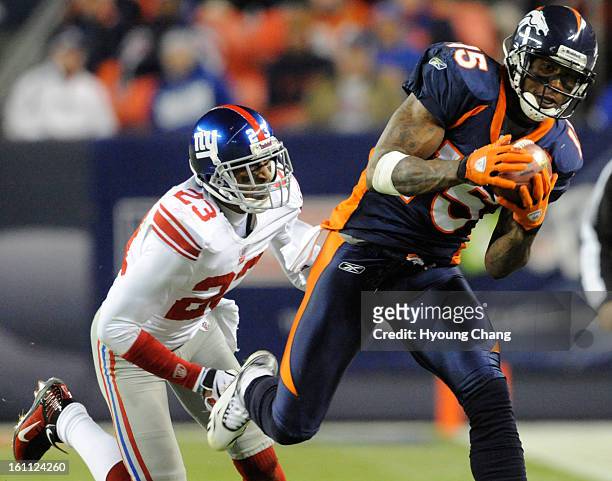 Denver Broncos wide receiver Brandon Marshall makes another one handed catch being defended by the New York Giants' Corey Webster, left, during the...