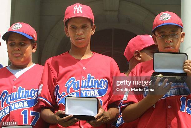 Danny Almonte and other members of the Rolando Paulino All-Stars Bronx Little League baseball team hold their keys to the city during a ceremony...