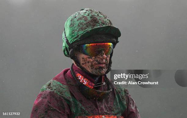 Andrew Thornton is pictured covered in mud at Newbury racecourse on February 09, 2013 in Newbury, England.