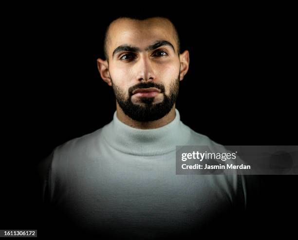 young man portrait on black background - high contrast stock pictures, royalty-free photos & images