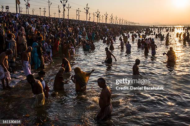 Hindu devotees bathe on the banks of Sangam, the confluence of the holy rivers Ganges, Yamuna and the mythical Saraswati, during the Maha Kumbh Mela...