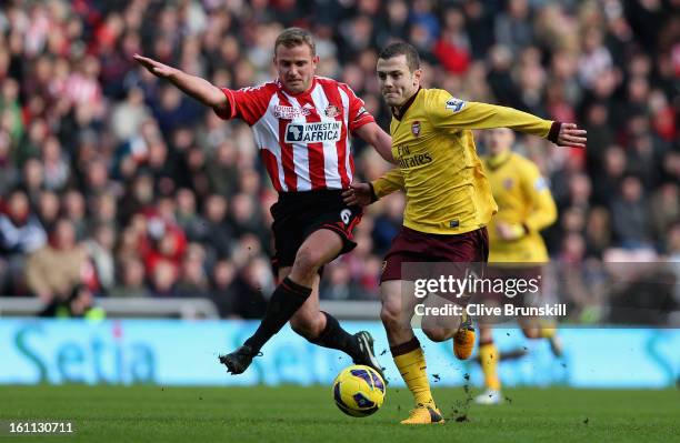 Jack Wilshere of Arsenal holds off a challenge from Lee Cattermole of Sunderland during the Barclays Premier League match between Sunderland and...