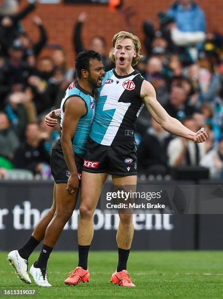 Miles Bergman of Port Adelaide celebrates a goal with Junior Rioli of Port Adelaide during the round 22 AFL match between Port Adelaide Power and...