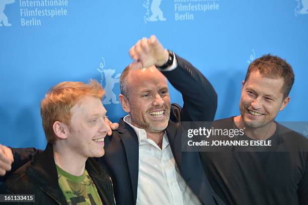German actor Til Schweiger and British actor Rupert Grint pose with Swedish director Fredrik Bond during a photocall for the film "The Necessary...