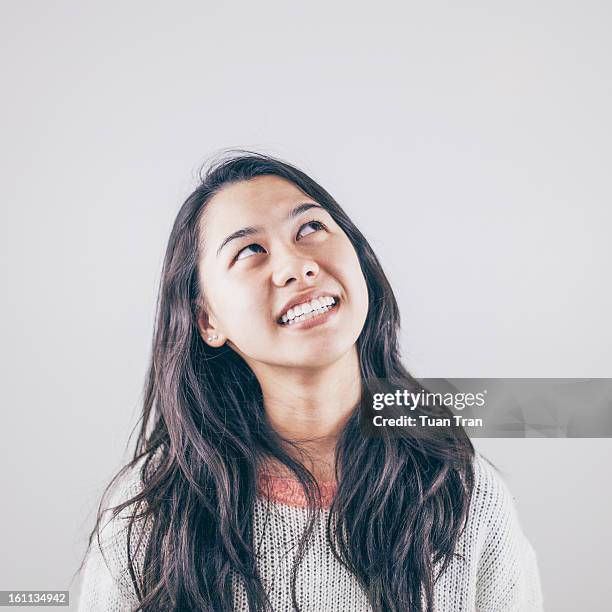 teenage girl against white background, looking up - girl thinking stock pictures, royalty-free photos & images