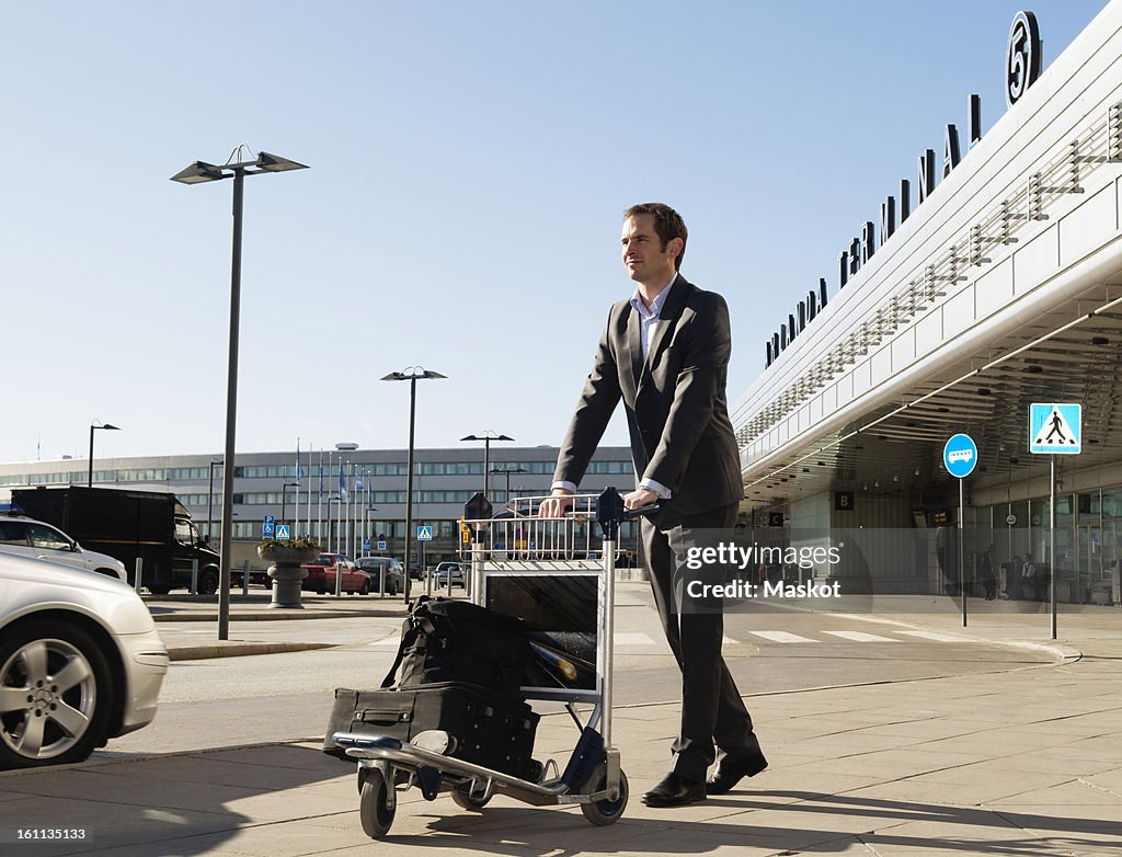 Man with trolley at parking lot
