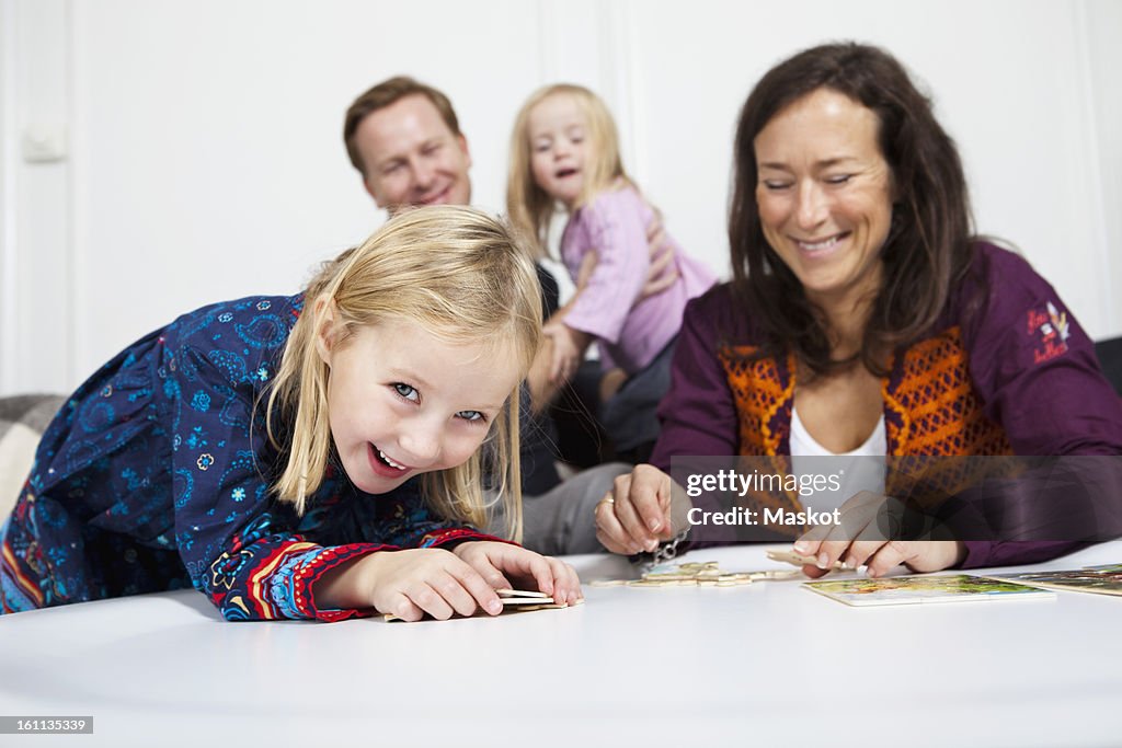 Parents and daughter (2-4) smiling