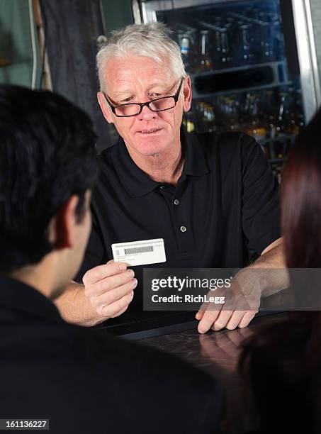 bartender checking id - id badge stock pictures, royalty-free photos & images