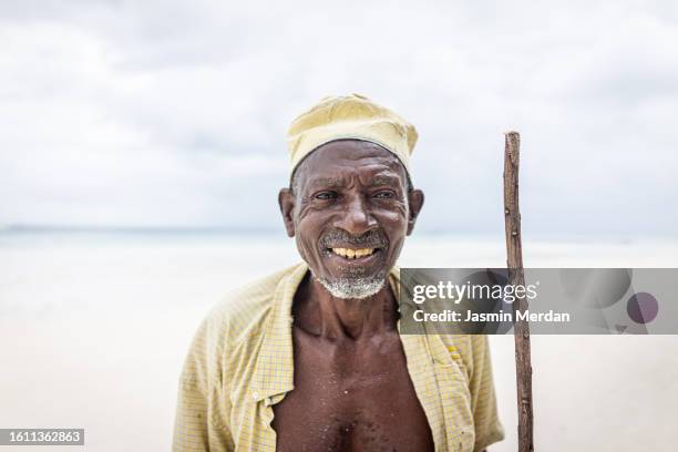 old african man on beach - shepherds staff stock pictures, royalty-free photos & images