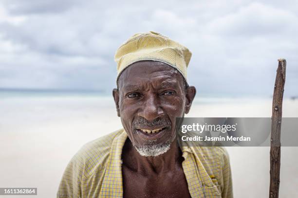 old african man on beach - shepherds staff stock pictures, royalty-free photos & images