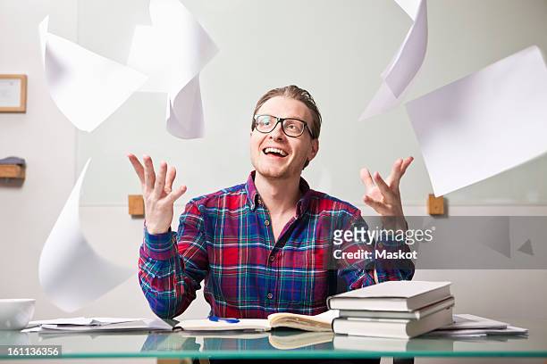 man throwing papers in air at office - throwing paper stock pictures, royalty-free photos & images