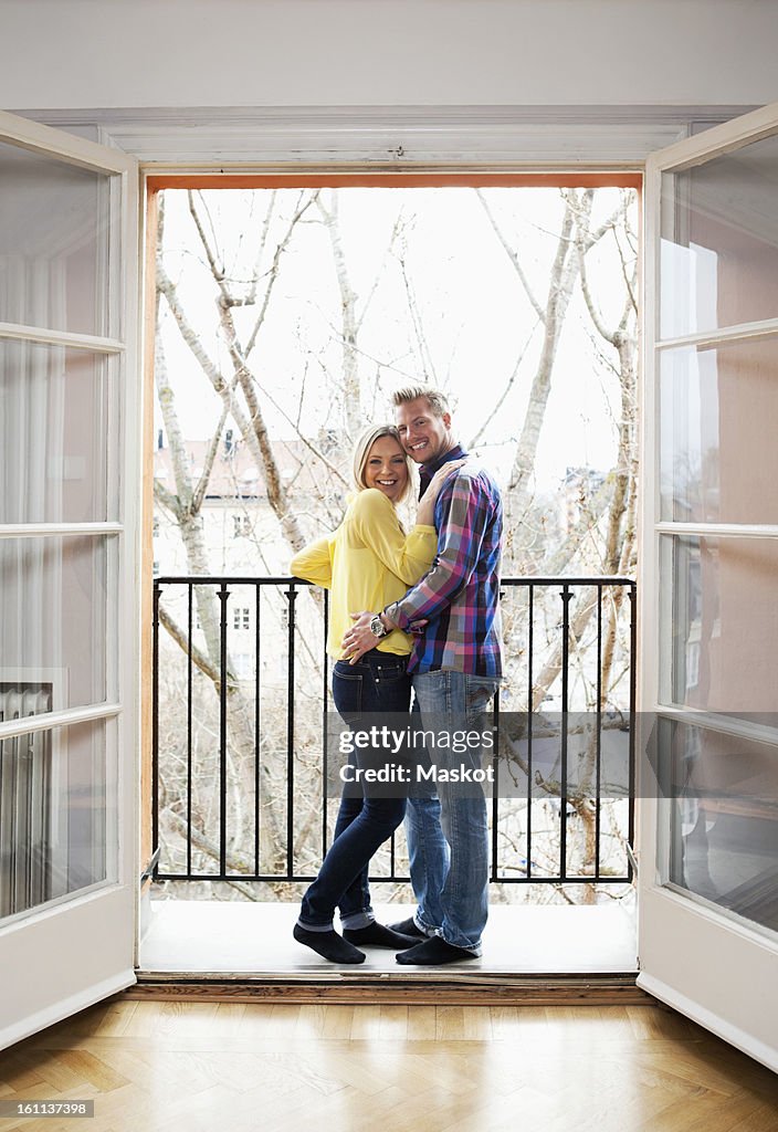 Mid adult Couple hugging in balcony