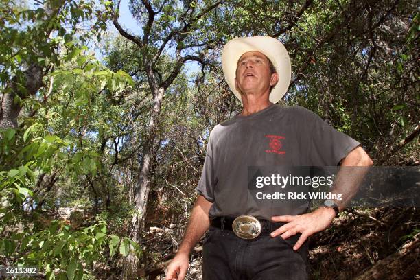 President George W. Bush gives the press a tour in a canyon he calls "The Cathedral" on his ranch August 25, 2001 in Crawford, Texas.