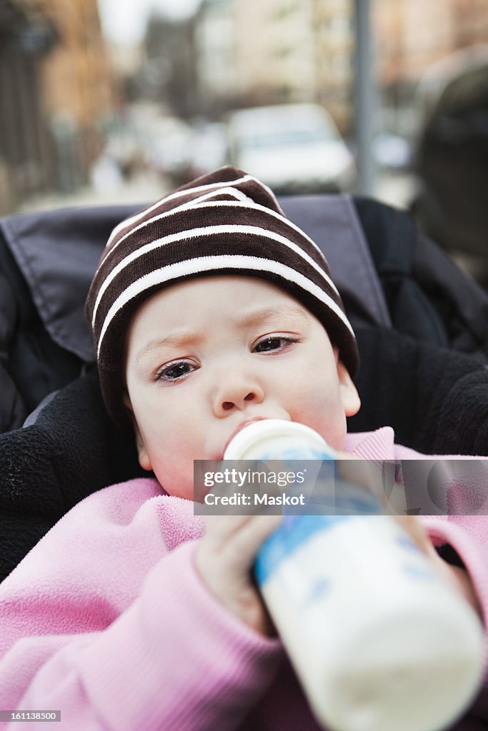 Close-up of baby (0-11 months) holding feeding bottle