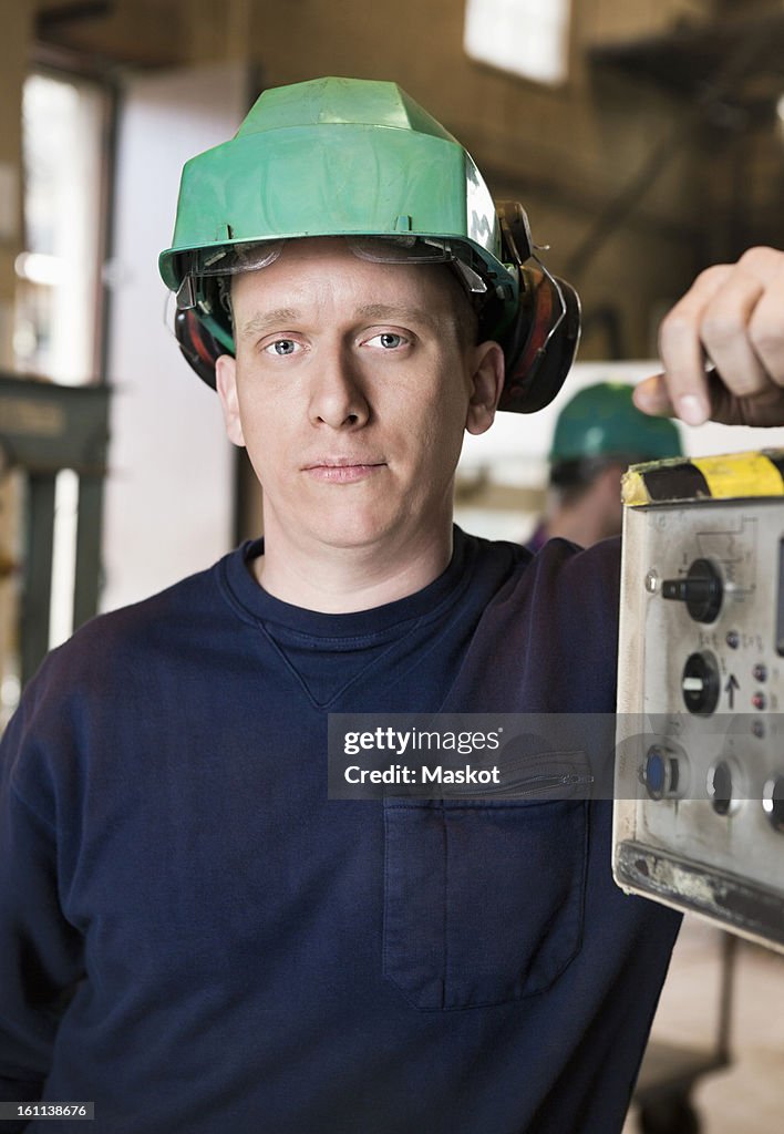 Man in green helmet looking at camera