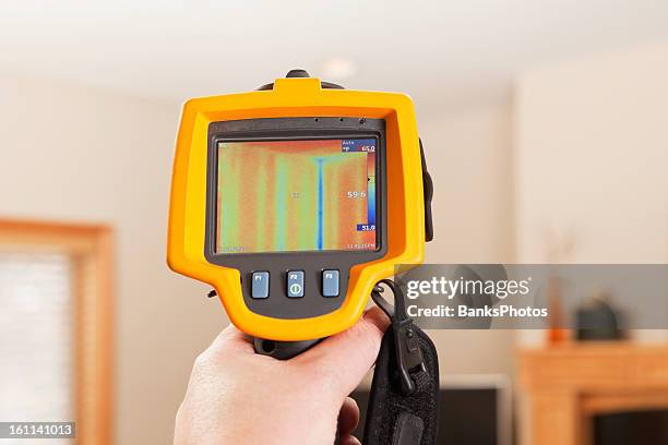 infrared thermal imaging camera pointing to house wall - infrared stockfoto's en -beelden