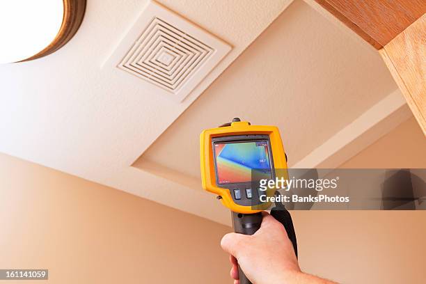 infrared thermal imaging camera pointing to attic access - thermal image stock pictures, royalty-free photos & images