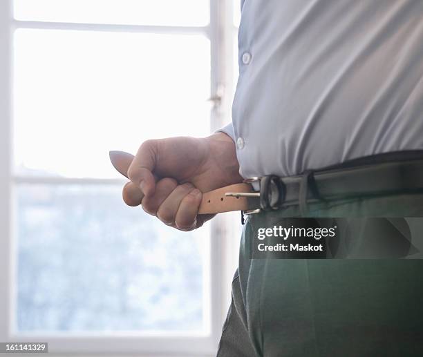 man fasten his belt - tighten stock pictures, royalty-free photos & images