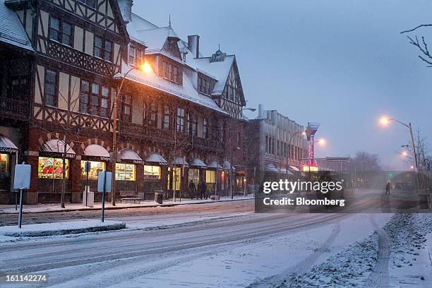 Pedestrian crosses a snow covered street during Winter Storm Nemo in Brookline, Massachusetts, U.S., on Friday, Feb. 8, 2013. More than two feet of...