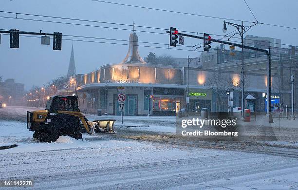 Snow plow clears Harvard Avenue during Winter Storm Nemo in Brookline, Massachusetts, U.S., on Friday, Feb. 8, 2013. More than two feet of snow fell...