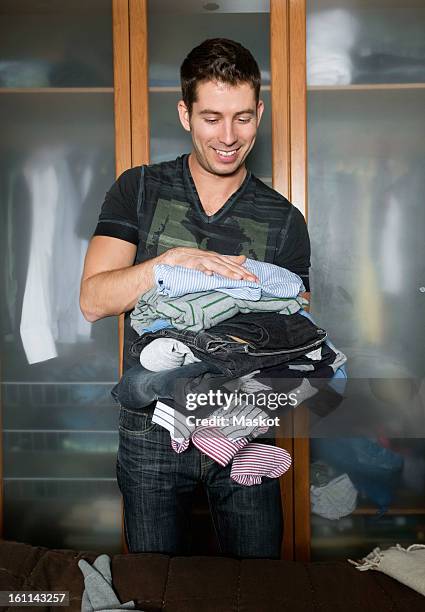 man folding laundry - clean closet stock pictures, royalty-free photos & images