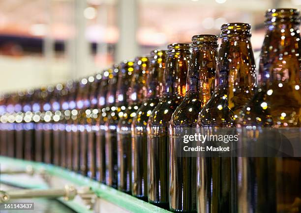 bottles in a row - bottle factory stock-fotos und bilder