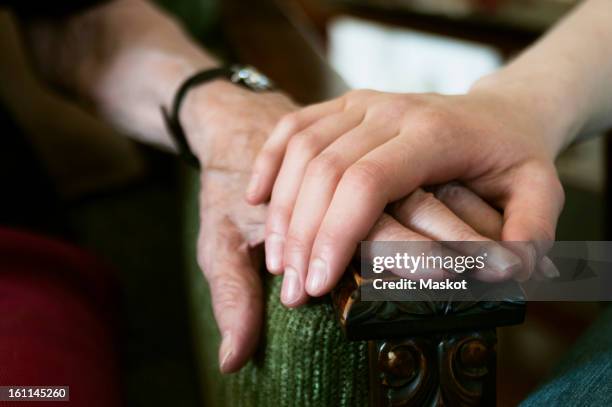 closeup on two hands - armrest stock pictures, royalty-free photos & images