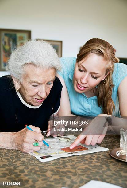 two people solving crosswords - doing a favour stock pictures, royalty-free photos & images