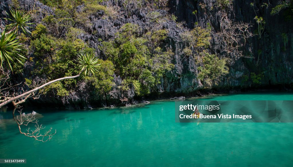 Woman paddling on a yellow canoe