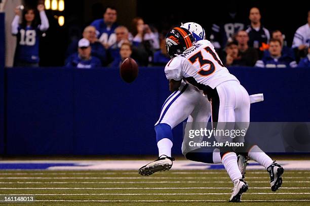 The Denver Broncos cornerback Darcel McBath knocks the ball loose from tight end Dallas Clark in the 2nd half vs. The Indianapolis Colts at Lucas Oil...