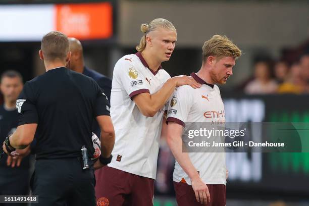 Kevin De Bruyne of Manchester City is embraced by teammates Erling Haaland as he leaves the pitch with an injury during the Premier League match...