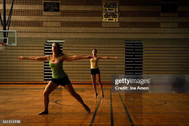 10th graders Tia Cooper and Olivia Quinn dance across the gymnasium floor in the morning light Monday at Monarch High School. They are members of the...