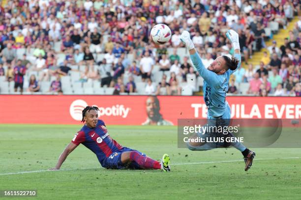 Barcelona's French defender Jules Kounde challenges Cadiz's Argentinian goalkeeper Jeremias Ledesma 'Conan' during the Spanish Liga football match...