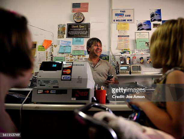 Martin Palumbo smiles at his customers as they check out from the The Friday Store, Inc. In Arvada. Palumbo and his wife Jo own the store that is...