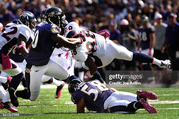 Baltimore Ravens linebacker Edgar Jones and linebacker Jason Phillips crush Denver Broncos wide receiver Demaryius Thomas and cause a fumble that is...