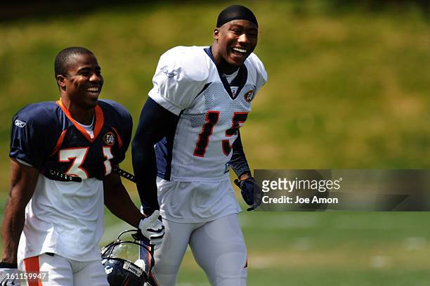 Broncos receiver Brandon Marshall runs onto the field with safety Darcel McBath before practice Tuesday afternoon at Dove Valley. Joe Amon / The...