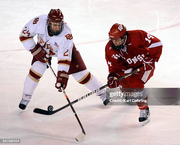 Wisconsin center Jefferson Dahl tried to work the puck past DU defenseman John Ryder in the second period. The University of Denver Pioneers men's...