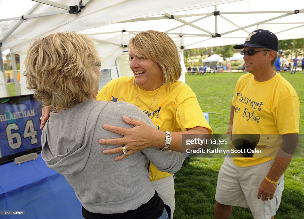 The Blakeman family celebrates the third annual 'Concert for Kyle' on Saturday, August 29th at 1pm MT at Civic Green Park in Highlands Ranch, themed "Remember, Celebrate, Educate." Joanna Blakeman, center, is greeted by friend Stacy Moriarty with Brad Bla